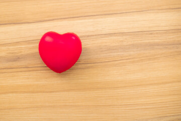 Red heart love shape hand training ball on wooden background: Hospital life insurance concept: World Heart Health Day. doctor's day, world hypertension day