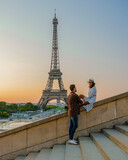 Fototapeta Paryż - Young couple by Eiffel tower at Sunrise, Paris Eifel tower Sunrise man woman in love, valentine