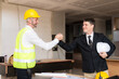© ArLawKa - Meeting of engineers or architects shaking hands for project Work with partners and engineering tools to create workplace models and blueprints. construction concept