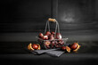 © Westend61 - Chestnuts in wire basket standing against black background