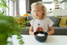 Blond Girl Refusing Meal In Bowl At Home
