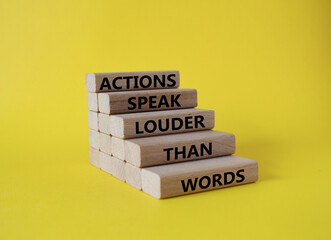 Wall Mural - Actions speak louder than Words symbol. Wooden blocks with words Actions speak louder than Words. Beautiful yellow background. Business and Actions concept. Copy space.