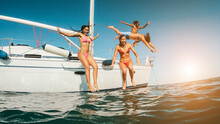 Happy Friends Diving From Sailing Boat Into The Sea - Soft Focus On Girls Faces - Travel, Summer Vacation And Lifestyle Concept