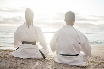 Sticker - A fighters state of mind. Rearview shot of two unrecognizable martial artists meditating while practicing karate on the beach.