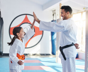 Sticker - Courage conquers all. Shot of a young man and cute little girl practicing karate in a studio.