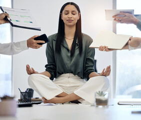 Canvas Print - When you calm the inside, the outside will follow. Shot of a young businesswoman meditating on a desk in a demanding work environment.