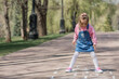 © Юлия Клюева - A happy girl in pink clothes draws classics with chalk on the asphalt on the street. Portrait of a little girl playing and jumping hopscotch on a sunny summer day. Creative development of children.
