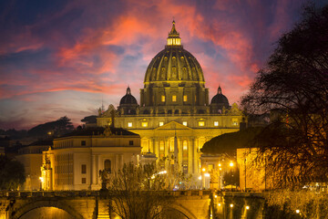 Romantic photo of St. Peter's basilica in the Vatican at sunset with red and fiery clouds. Church symbol of the religion of Christianity, home of Pope Francis. Rome Italy Europe Unesco heritage