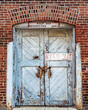 Background shot of old warehouse doors set in a brick wall with a 