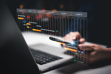 Planning and Implementation, Business people use laptop computers to manage work projects and update tasks. Work progress, efficient scheduling.Business Data Management scheduling interface