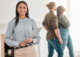 Canvas Print - Successful sales makes me smile. Shot of a real estate agent showing a young couple their newly purchased home.