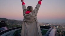 Celebrating Love For Life, Carefree Young Woman Jumps In Convertible Open Car With Heart Full Of Happiness And Soul Filled With Freedom. Female Wanderlust Enjoying Travel Exploring New Destination