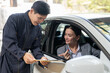 © Supachai - Car mechanic man in uniform explaining checklist car maintenance and repair to woman client at auto car garage service