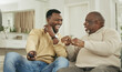 © Siphosethu Fanti/peopleimages.com - A happy family is but an earlier heaven. Shot of a father and son laughing in the lounge.