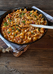 Wall Mural - Creamy ground beef with pasta shells in a cast iron pan