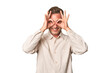© Asier - A middle-aged man isolated showing okay sign over eyes