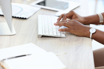 Wall Mural - Working hard to achieve my goals. Cropped shot of a businesswoman typing on her keyboard.