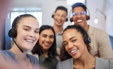 Fototapete - Were all eager to answer your calls. Portrait of a group of call centre agents taking selfies in an office.