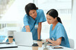 © K.A./peopleimages.com - Lets do some research. Shot of two young female doctors using a laptop at a hospital.