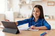 © Prostock-studio - Happy Schoolgirl Using Digital Tablet Doing Homework Online At Home