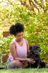 Canvas Print - A multi-ethnic woman and her happy dog, giving attention in the park pet owner