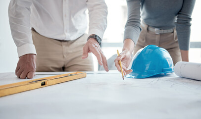 Wall Mural - Making sure the plans are up to code. Cropped shot of two unrecognizable architects looking over blueprints in the office.