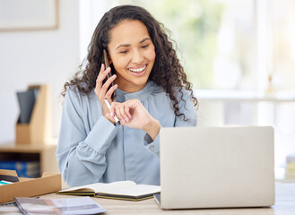 Canvas Print - Shes been having the most productive day. Shot of a young businesswoman writing notes while talking on a cellphone and using a laptop in an office.