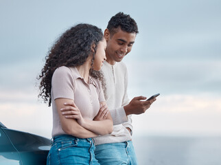 Poster - Where are we going next. Shot of a young couple using a phone on a road trip together.