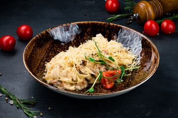 Poster - Linguini pasta with bacon, onion, mushrooms, cheese, tomatoes and herbs on a dark.