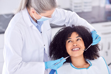 Poster - .. Shot of a young female patient having her teeth examined at the dentist.