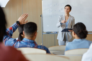 Wall Mural - Teacher asking questions to students during lecture at lecture hall