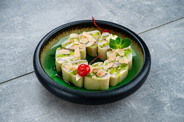 Poster - Set of sweet maki sushi rolls with pancake, cream cheese, mango, almonds, mint and kiwi sauce.