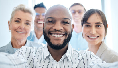 Youve got to appreciate the value of teamwork. Portrait of a group of confident businesspeople taking selfies together in an office.