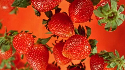Aufkleber - Super slow motion of rotating strawberries on red background, top view. Filmed on high speed cinema camera, 1000 fps, placed on high speed cine bot. Speed ramp effect.