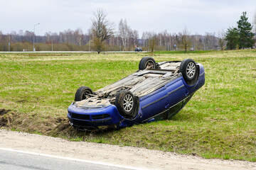 Wall Mural - Car accident scene, a passenger car left the road and overturned upside, car rollover