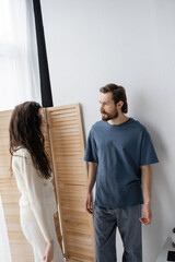 Wall Mural - Angry couple in pajama quarrelling during relationship difficulties at home in morning.