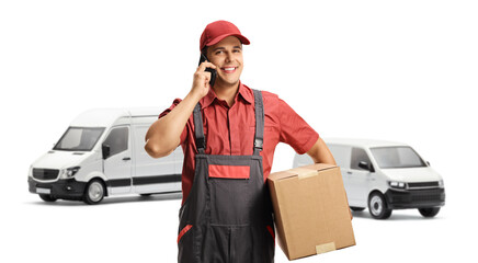 Poster - Male worker with a delivery box using a mobile phone and standing in front of white vans