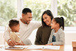 © K.A./peopleimages.com - Our kids are happy at their school. Shot of a young family doing homework together at home.
