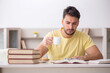 © Elnur - Young male student studying at home