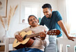 © N Felix/peopleimages.com - He loves listening to his dad play. Shot of a young man listening to his father play the guitar at home.