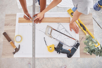 Wall Mural - Weve divided our entire renovation into sub-plans. Shot of two people discussing a blueprint.