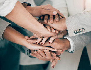 Poster - Weve got all the motivation we need. Shot of a group of unrecognizable businesspeople stacking their hands at work.