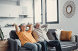 © Daniel - Peaceful middle aged man and woman with closed eyes relaxing on comfortable couch at home, mature family daydreaming together, grey haired wife and husband resting with hands behind head, breathing.