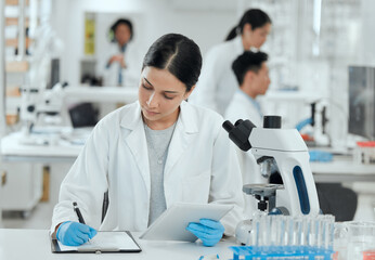 Wall Mural - shes in the zone. shot of a young woman making notes in her lab.