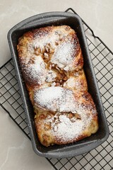 Wall Mural - Delicious yeast dough cake in baking pan on marble table, top view