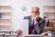 © Elnur - Old male boss employee working in the office