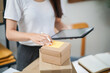 © Charlie's - Business From Home Asian woman preparing package delivery box Shipping for shopping online. young start up small business owner at home online order