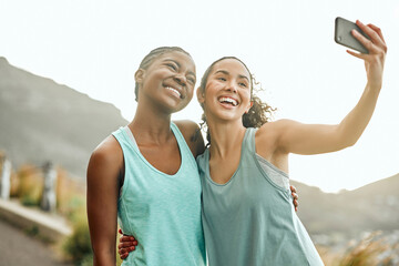 Wall Mural - Building our dream bodies together. Shot of two friends taking selfies during a workout.