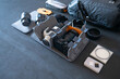 Professional photography equipment and a canvas bag on a gray table. view from above.