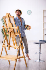 Canvas Print - Young man enjoying painting at the studio